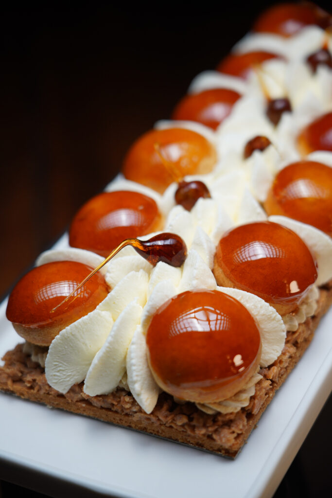 Gâteau Bouton de neige avec choux caramélisés, chantilly et base croustillante pralinée.